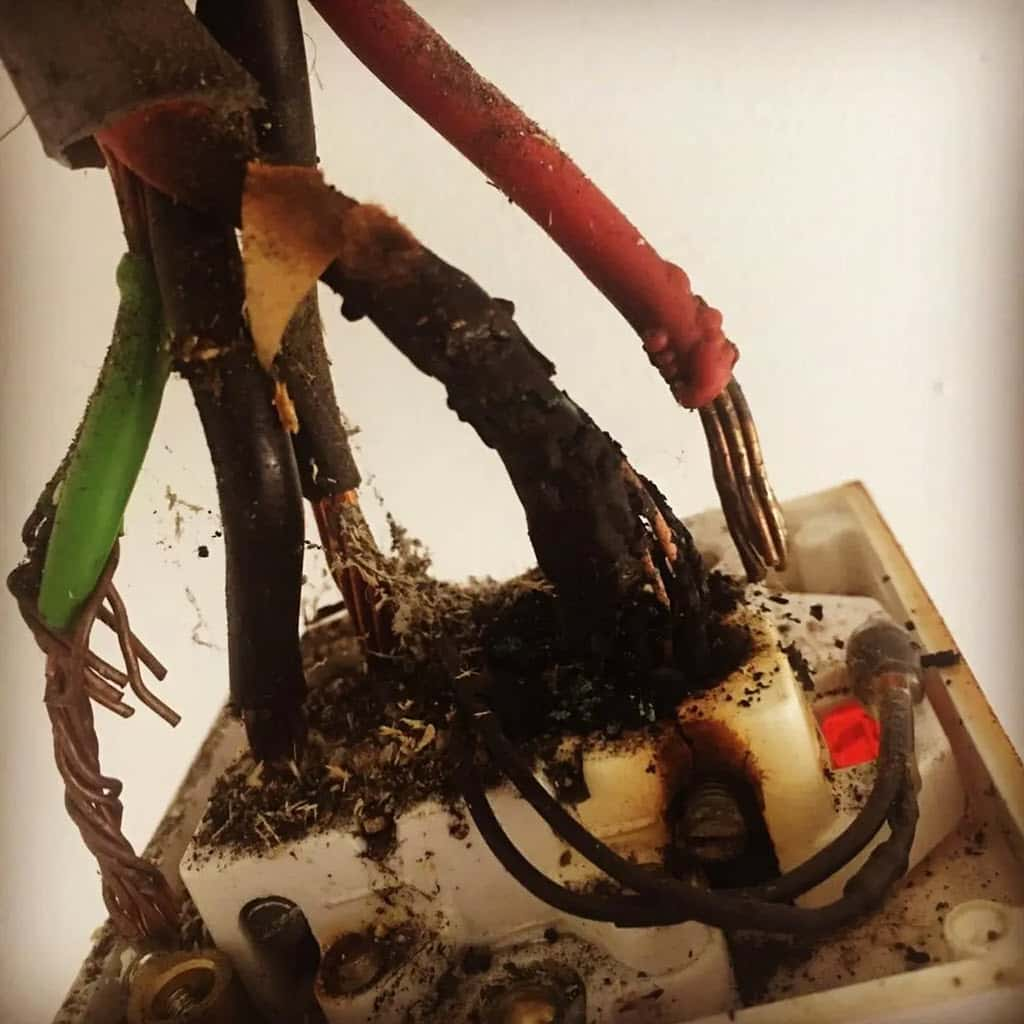 Burnt out double pole switch on an electric storage heater in Edinburgh.