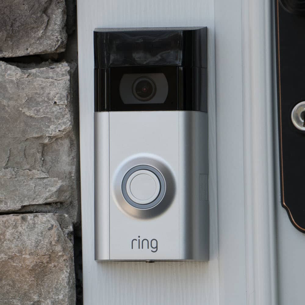 A smart Ring doorbell installed by the front door.