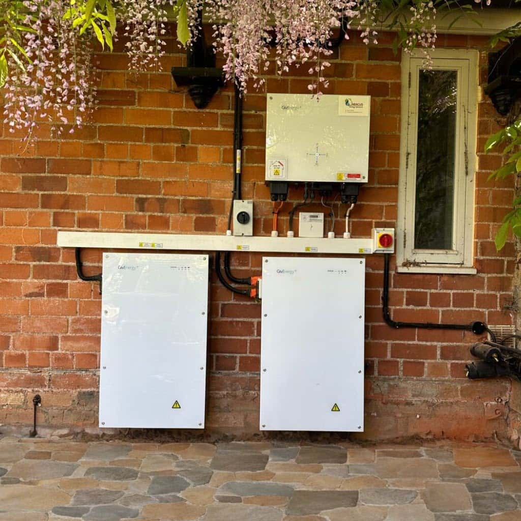 Battery storage system on oustide wall with two batteries.