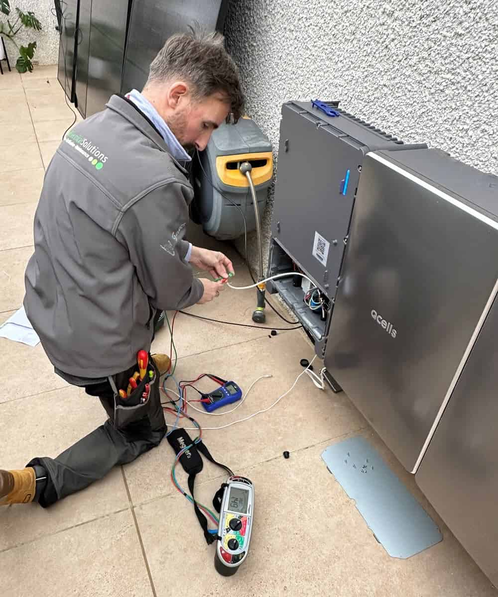 Electrical setup and testing during the battery storage installation process.